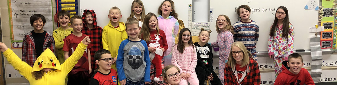 Students smile as they eat lunch in a classroom